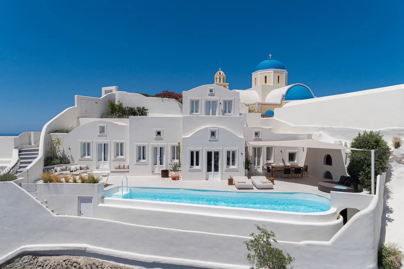 Canaves villa with blue-domed church above