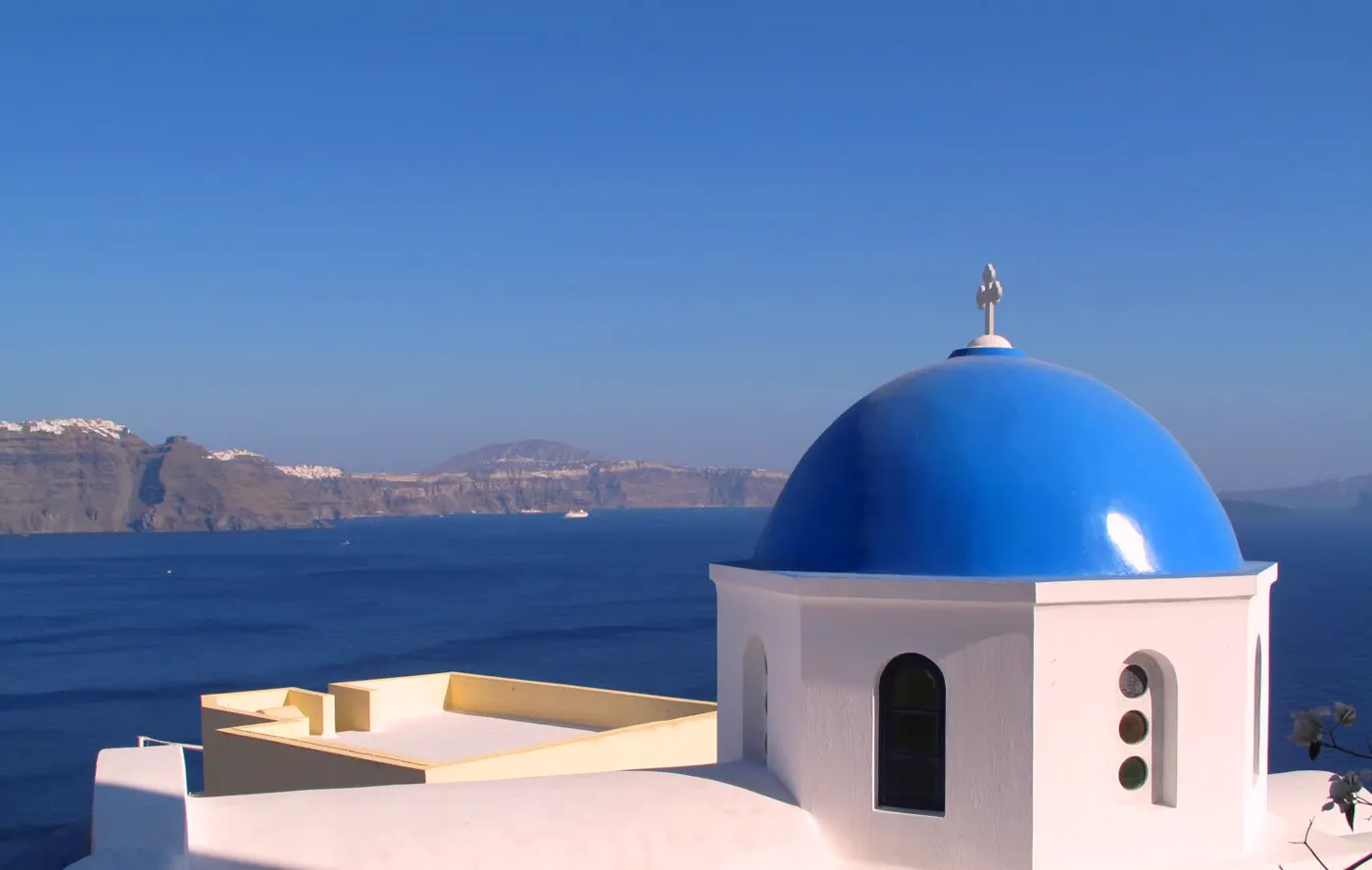 A blue-domed church above the Santorini caldera
